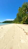 Secluded white sandy beach in Thailand. Cinematic FPV drone flight video