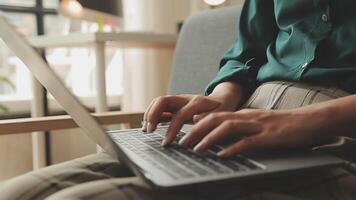 Hands of young contemporary office manager over laptop keypad during work over new business project by table video