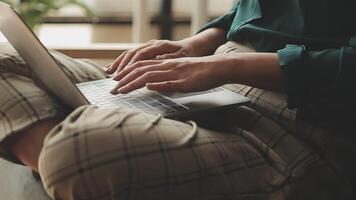 Hands of young contemporary office manager over laptop keypad during work over new business project by table video