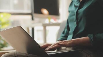 Hands of young contemporary office manager over laptop keypad during work over new business project by table video