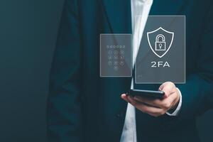 Enhancing cybersecurity with 2FA Two-Factor Authentication, Login Security, User ID Protection, and Encryption to thwart cyber hackers. Businessman holding mobile internet online network. photo