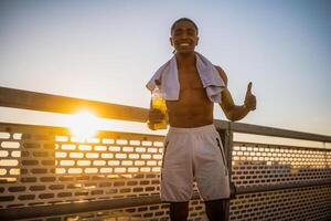 Portrait of young happy african-american man who is ready for exercising and jogging. photo