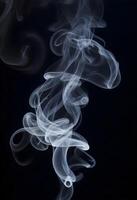 AI generated White smoke fragments on black background photo