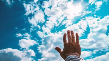 ai generado del hombre mano alcanzando arriba en azul cielo con blanco nubes antecedentes foto