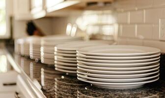 AI generated Closeup of clean plates on countertop in modern kitchen at home photo