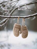 AI generated A pair of knitted mittens hanging on a branch in winter photo