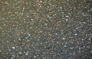 Surface grunge rough of asphalt. Tarmac dark grey grainy road. Texture Background Top view photo