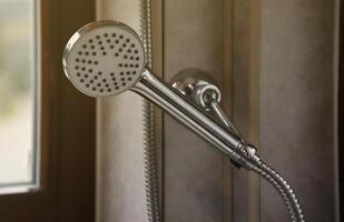 Silvery shower in modern hotel bathroom with natural light photo