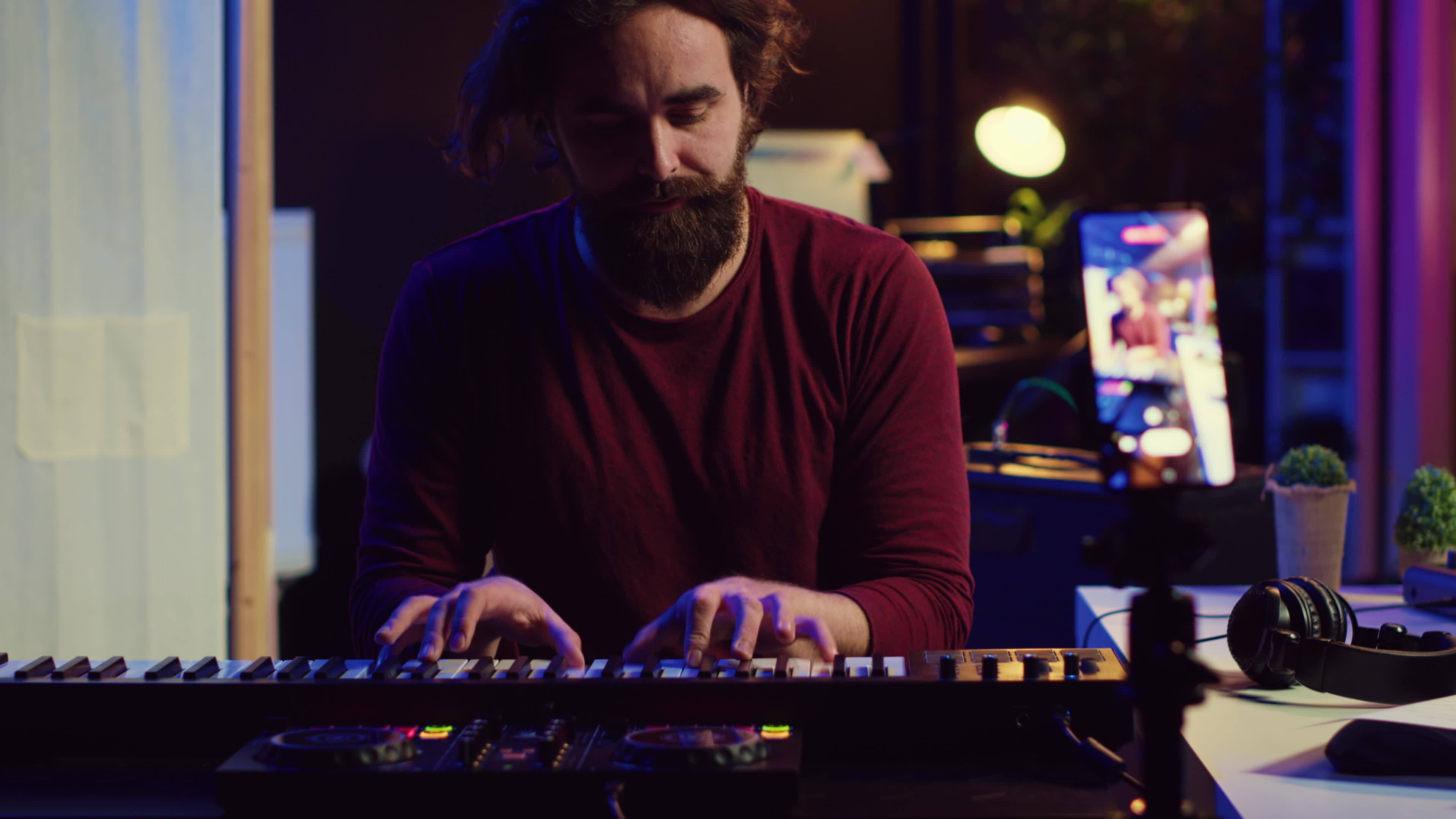 Artist teaching online piano lessons from his home studio, recording