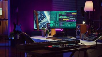 Empty space used for producing music and sounds with electronic devices, acoustics instruments and soundboard with controls. Home studio equipped with amplifier and mastering tools. Camera A. video