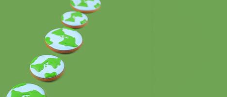 Earth Day concept. Cookies in shape of Earth on green backdrop. Banner image. photo