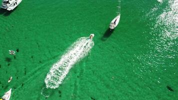 Aerial panoramic view of seascape with crystal clear azure sea and rocky shores. Yachts in a beautiful lagoon on backdrop of rocks. The concept of an ideal destination for summer travel and vacation. video