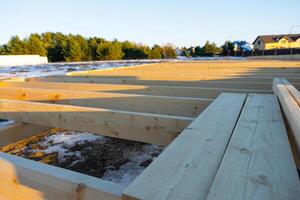 The foundation of a wooden frame house on stilts is a construction site, the process of building a frame photo