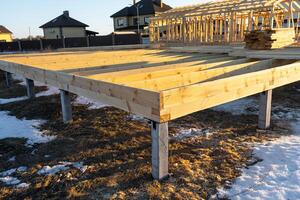 The foundation of a wooden frame house on stilts is a construction site, the process of building a frame photo