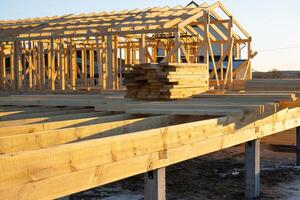 The foundation of a wooden frame house on stilts is a construction site, the process of building a frame photo