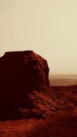 aerial view of a massive rock formation standing proudly in the desert video