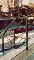 An abandoned swimming pool with a rusted metal railing video