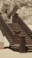 A set of stairs in the sand with a rock in the background video