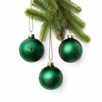 Decorative Christmas balls adorning a snowy white backdrop with foliage from a fir tree. photo