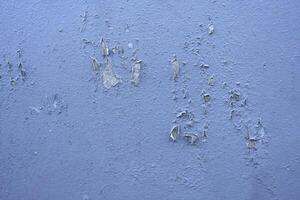 White peeling paint wall surface with moldy.Weathered concrete pattern wall.Old white color painted peeling off moment to do can see raw concrete texture wall.Swelling concrete wall texture. photo