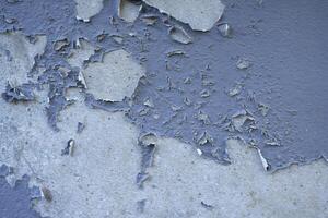 White peeling paint wall surface with moldy.Weathered concrete pattern wall.Old white color painted peeling off moment to do can see raw concrete texture wall.Swelling concrete wall texture. photo