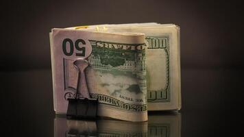 stack of dollar bills collected in an elastic band and a stationery clip video