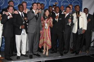 LOS ANGELES, JUL 14 - Reggie Bush, Jeremy Shockey and Drew Brees pose along with members of the New Orleans Saints after winning the ESPY for Best Team in the Press Room of the 2010 ESPY Awards at Nokia Theater, LA Live on July14, 2010 in Los Angeles, CA photo