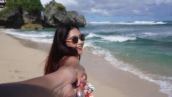POV of happy smiling woman on summer vacation at a beach. Female traveler holding hands and having fun on a beach holidays, travel and adventure lifestyle. video