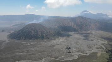 Antenne Aussicht von aktiv Vulkan mit Krater im Tiefe. braun Schmutz um. Wolken von Rauch auf Vulkan, montieren Brom, Indonesien video