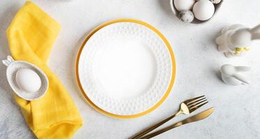 Easter table setting mock up. Restaurant festive menu template in white and yellow. Top view. Banner photo