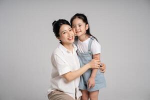 Portrait of an Asian mother and daughter posing on a white background photo