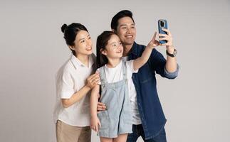 Asian family portrait posing on white background photo