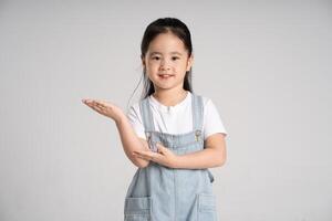 Portrait of a lovely Asian baby girl posing on a white background photo