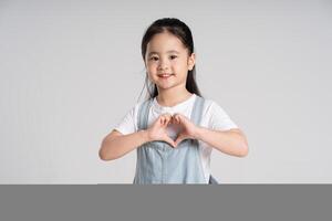 Portrait of a lovely Asian baby girl posing on a white background photo