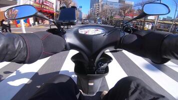 A point of view of driving by bike with smartphone at the downtown street in Tokyo video