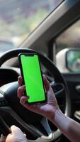 Car with phone, person using phone green screen on car video