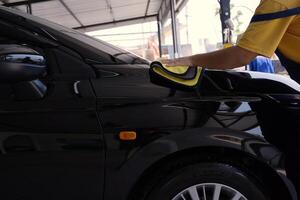 Worker washing car photo