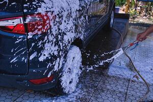 Worker washing car photo