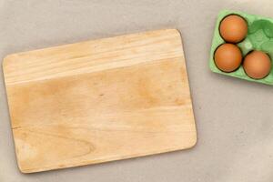 Green carton of eggs and cutting board. Easter background photo