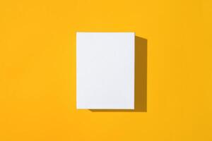 White empty small box mockup on yellow background top view. photo