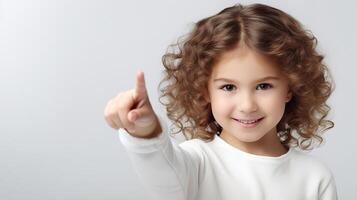 ai generado retrato de un linda pequeño caucásico niña señalando dedo gesto mientras en pie en un blanco antecedentes con Copiar espacio foto