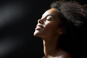 AI generated Side view portrait of smiling happy African American woman on dark background with closed eyes. photo