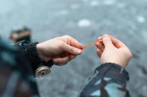 Male hands holding a fishing rod close-up. Winter fishing on the lake. photo