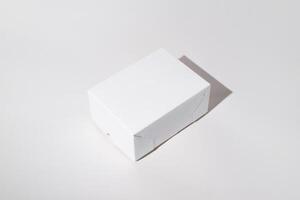 Small box mock up on a white background. Blank cardboard box surface side view, copy space. photo