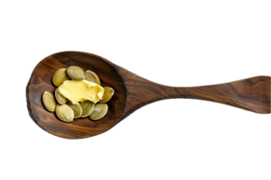 AI generated Pumpkin Seeds and Butter Curl on Wooden Spoon png