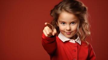 ai generado retrato de linda pequeño caucásico niña señalando con dedo mientras en pie en rojo antecedentes con Copiar espacio foto