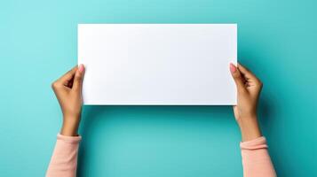 AI generated White sheet mockup, close-up of female black hands holding sheet of paper with empty space for announcement on blue background photo