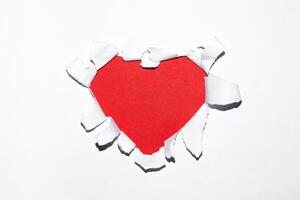 Happy Valentines Day background. Heart shaped red hole in paper. Empty space for text. photo