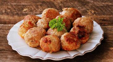 Fried meat ball, delicious meat cutlets on rustic dark table photo