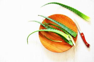 Leaf of fresh aloe vera on wooden plate , natural clear gel photo